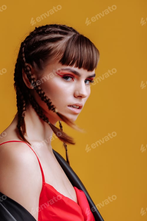 Preview: Beautiful female model in a red dress yellow background
