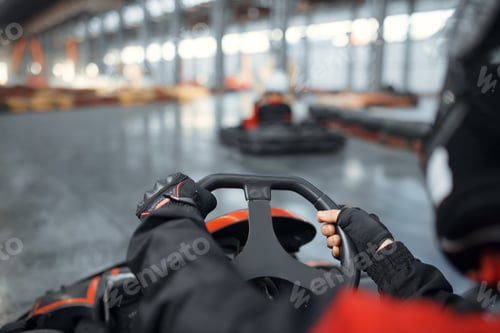 Preview: Racer in helmet driving go kart car