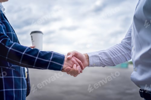 Preview: Crop businesspeople shaking hands on street