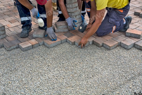 Preview: a group of men working on cement work next to each other