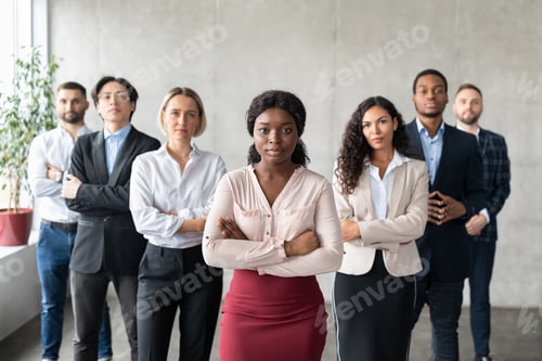 Preview: Determined Black Businesswoman Standing In Front Of Employees In Office