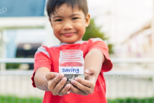 Preview: Boy Holds Jar of Coins for Saving