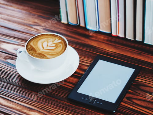 Preview: cup of latte or cappuccino with e-book in coffee shop with vintage retro filter effect