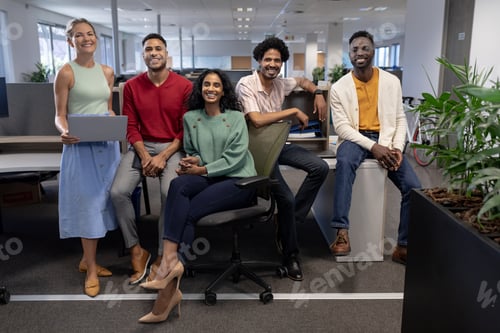 Preview: Full length portrait of smiling multiracial male and female advisors at modern workplace