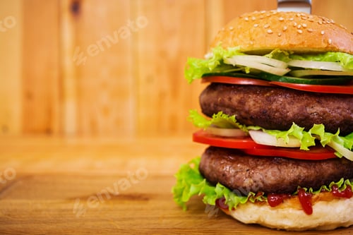 Preview: Delicious handmade burger on wooden background. Close view
