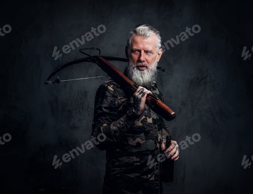 Preview: Bearded old man with grey hairs holding crossbow on his shoulder