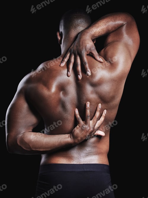 Preview: Your fix for the day. Rearview studio shot of a fit young man flexing against a black background.