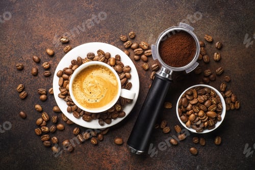 Preview: Cup of coffee, roasted coffee beans and filter holder at dark table.