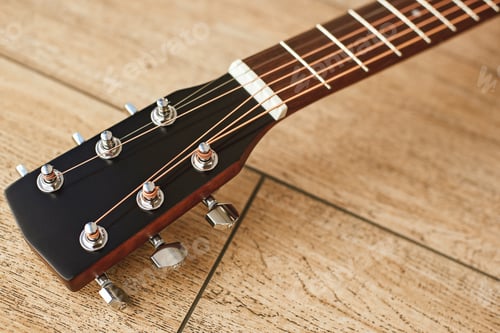 Preview: Uppermost part of the guitar. Close view of guitar headstock with tuning keys for adjusting guitar
