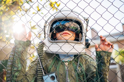Preview: Adorable kid with a astronaut uniform playing in the street