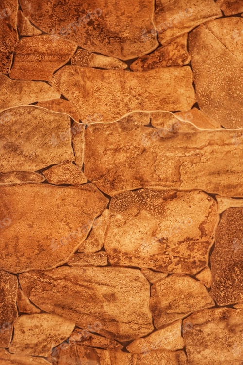 Preview: Close-up shot of a rough and textured rock wall in natural earthy tones