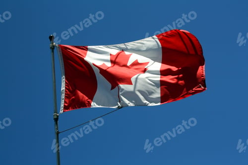 Preview: Flag of Canada waving against the blue sky