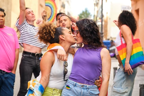 Preview: Lesbian couple kissing during International Pride Day celebration.