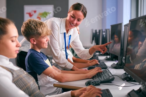 Preview: Group Of Secondary Or High School Students At Computers In IT Class With Female Teacher