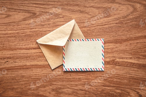 Preview: Envelope with a postcard for an inscription on a wooden background, flat lay.