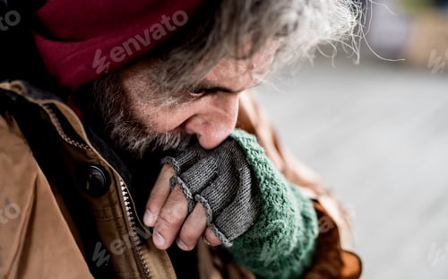 Preview: A close-up view of homeless beggar man standing outdoors in city.