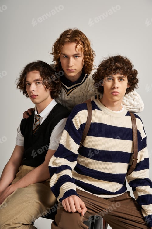 Preview: Young stylish friends showcase trendy fashion in a contemporary studio setting