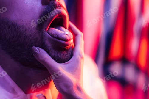 Preview: cropped view of man with LSD on tongue and woman touching his face