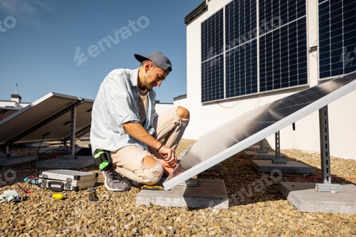 Preview: Man installing solar panels on the roof of his house