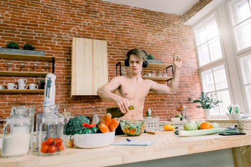 Preview: Healthy Eating And Nutrition Supplements. Handsome Male listening to music and dancing while