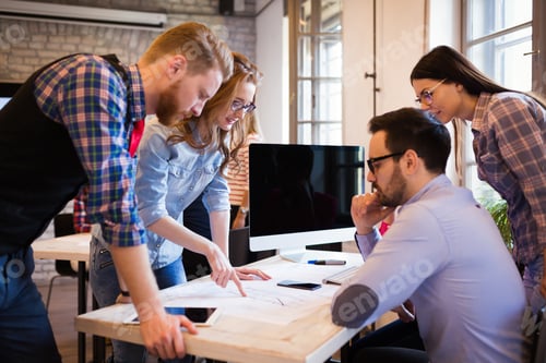 Preview: Coworkers working on project together in office