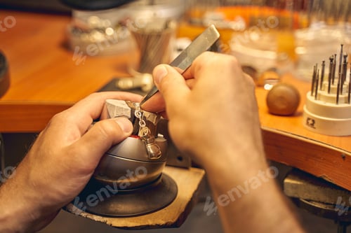 Preview: Male hands using a tool for stone setting