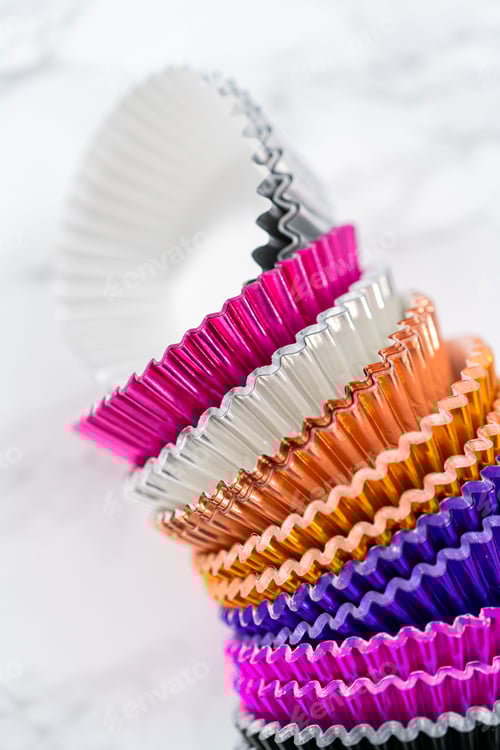 Preview: Stack of Colorful Baking Cupcake Liners on White