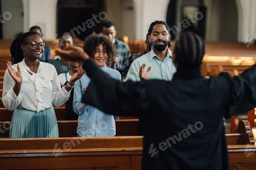 Preview: Preacher leading congregation in clapping during church service
