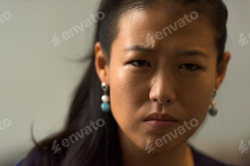Preview: Close-up portrait of beautiful rebel Asian woman face outdoors