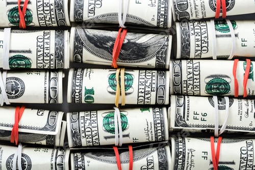 Preview: close up of cash rolls with colorful rubber bands