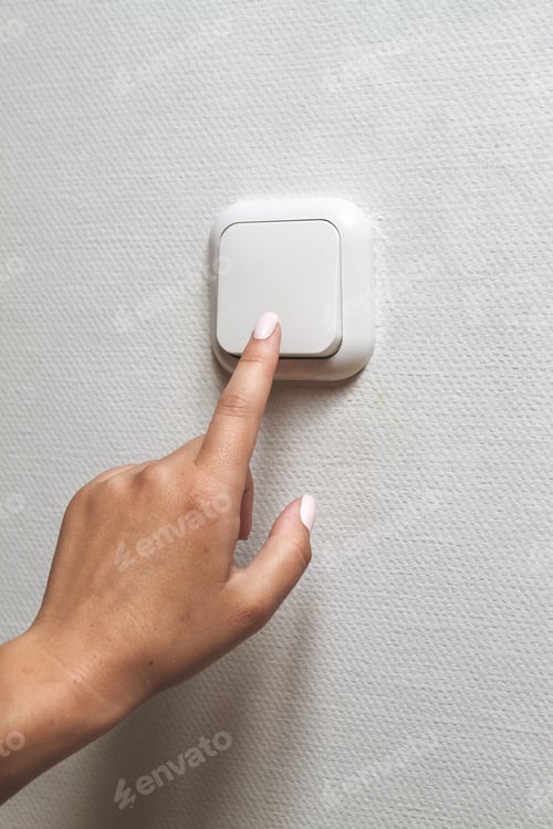 Preview: Female hand turns off the light indoors. Electrical energy savin