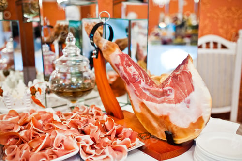 Preview: Pieces of meat jamon at catering wedding reception table.