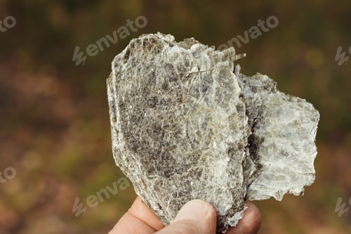 Preview: Macro photography of unprocessed pieces of mica minerals in a natural deposit.