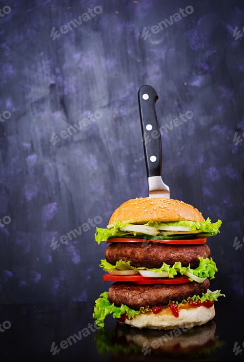 Preview: Delicious handmade burger on dark background. Close view