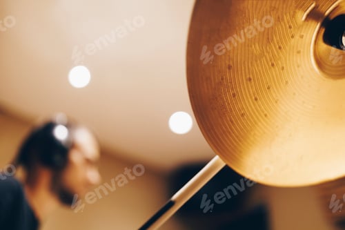 Preview: Man with headphones playing on drums
