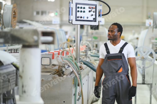 Preview: An African-American male worker in a plastic window frame factory