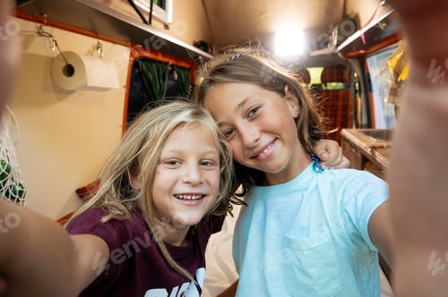 Preview: Happy children take a self on a wonderful day at camp. Van life concept.