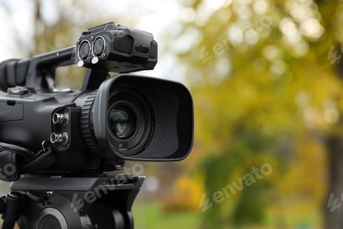 Preview: Professional video camera outdoors. Space for text