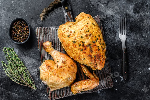 Preview: Butchered grilled whole chicken. Black background. Top view