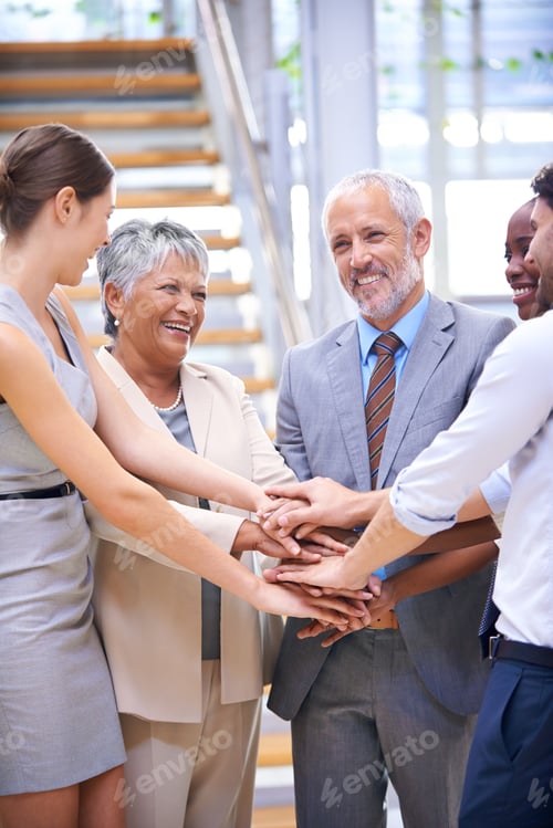 Preview: Teamwork is their secret. Cropped shot of a group of coworkers with their hands stacked.