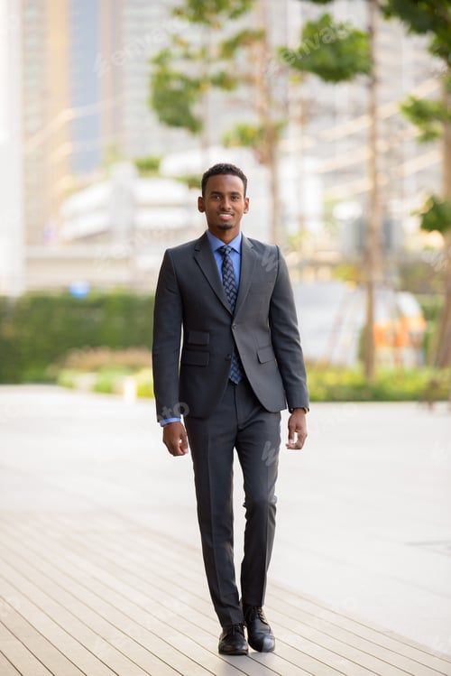 Preview: Full length shot of black businessman wearing suit in city