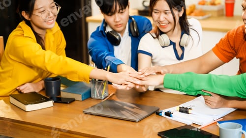 Preview: A group of young Asian college friends sitting on sofa at home,watching laptop,enjoying cheerful