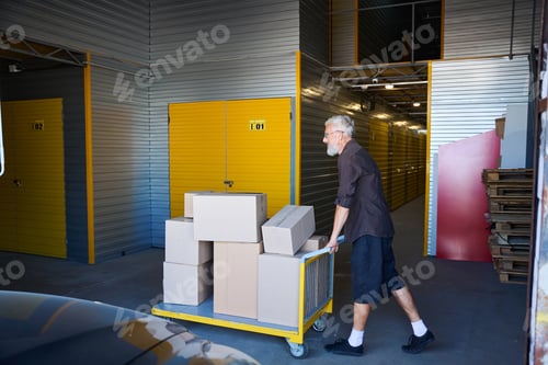 Preview: Middle-aged male is carrying a cart with things