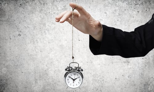 Preview: Close Up Of Businessman Holding Clock On Rope
