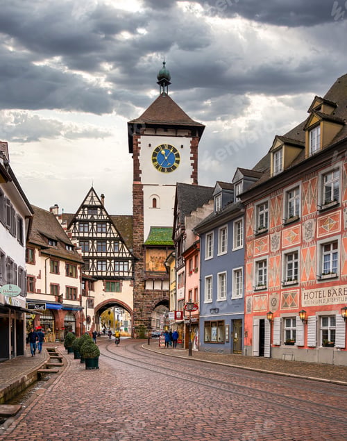 Preview: the cobblestone street in the old town is lined with colorful houses