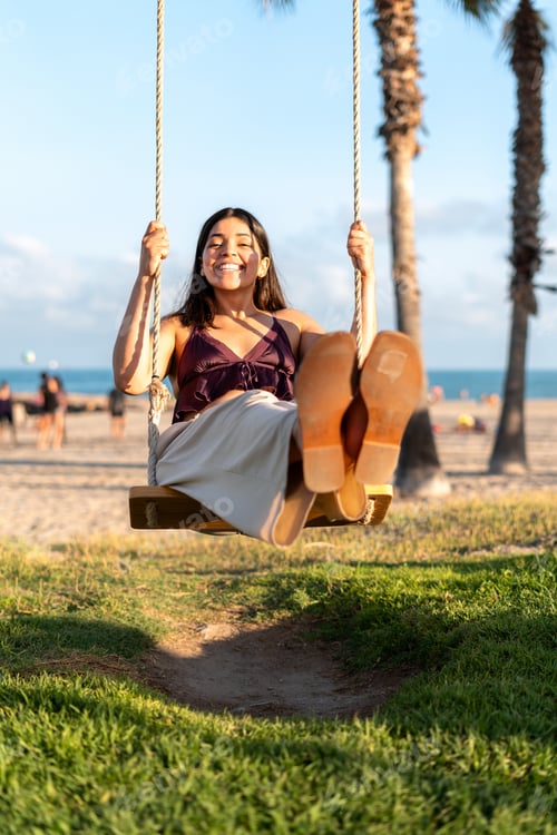 Preview: Happy tourist swinging on tropical beach with palm trees