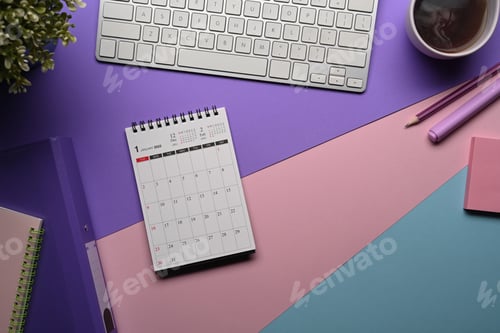 Preview: Above view calendar, notebook and coffee cup on colorful background.