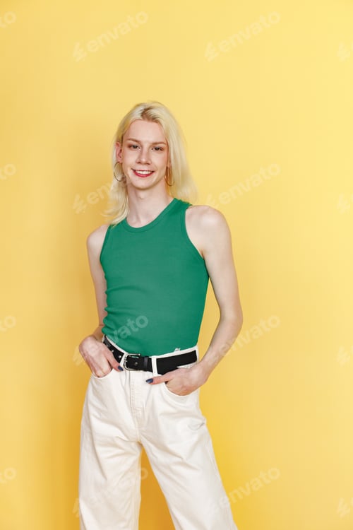 Preview: Studio photo of a fashionable man with make up isolated on yellow background