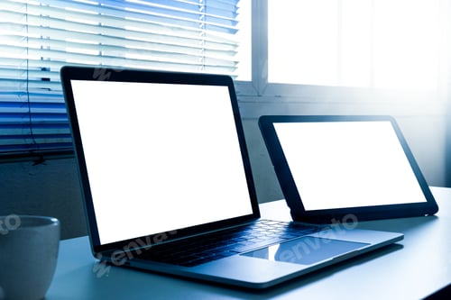 Preview: Blank screen laptop and tablet computer on the table