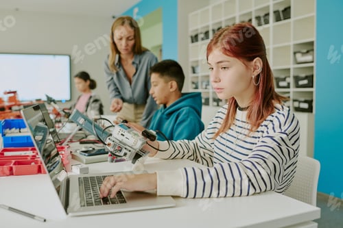 Preview: Red Haired Girl Using Laptop in Classroom